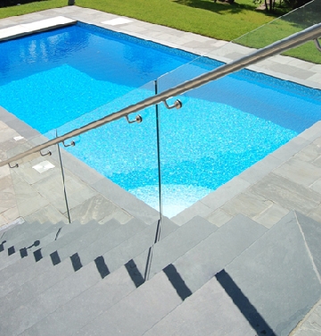slate steps and tiles by outdoor swimming pool